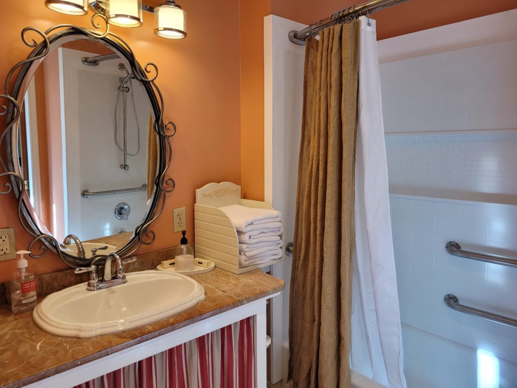 View of sink and bathroom of the courthouse cottage at Quincy Feather Bed Inn
