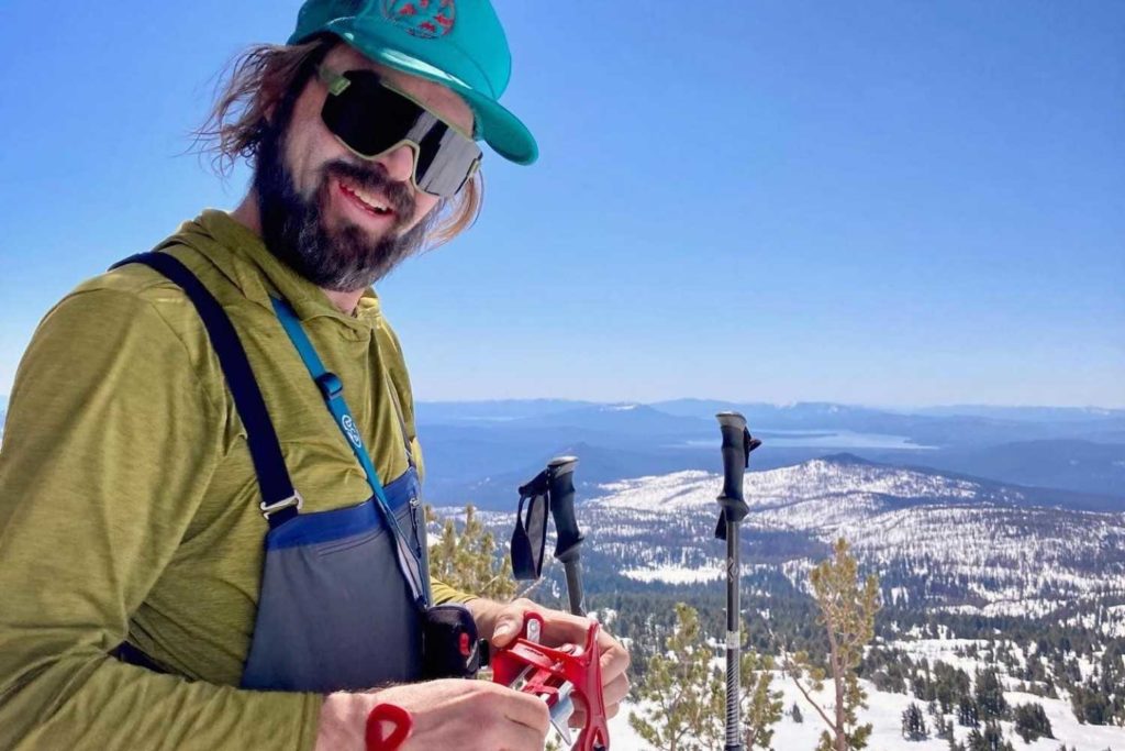 Skier on Lassen Peak with views of valley below in Lassen Volcanic National Park