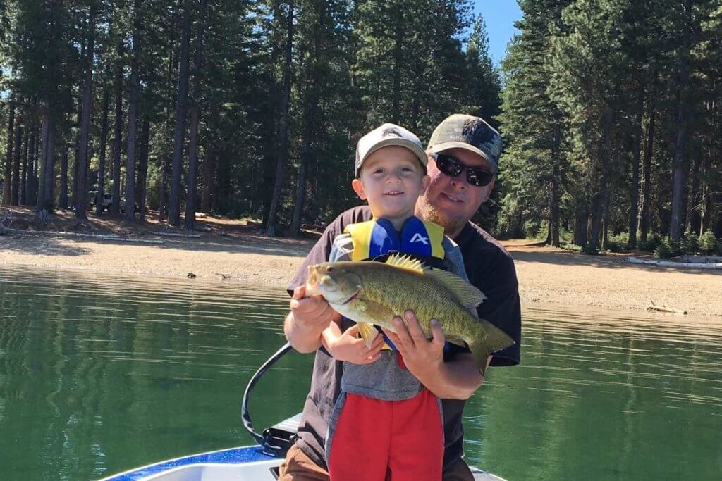 Son and Father holding fish on Lake Almanor