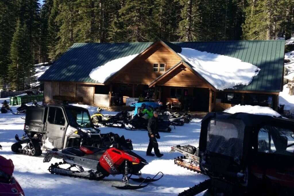 Group of snowmobilers in front of Bucks Lake Lodge