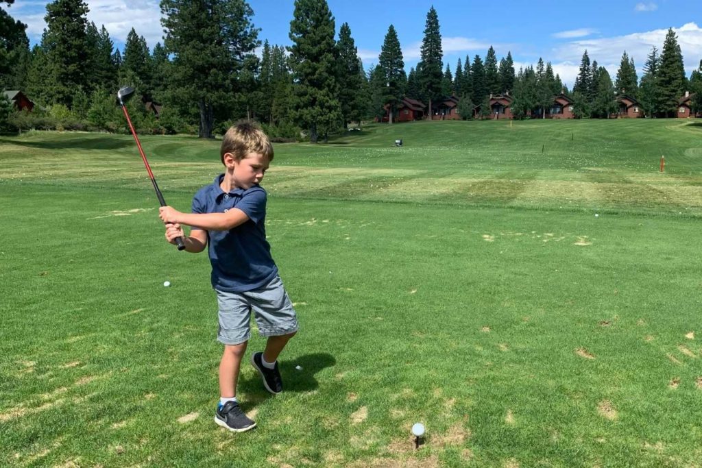 kid at tee on golf course in plumas county northern california