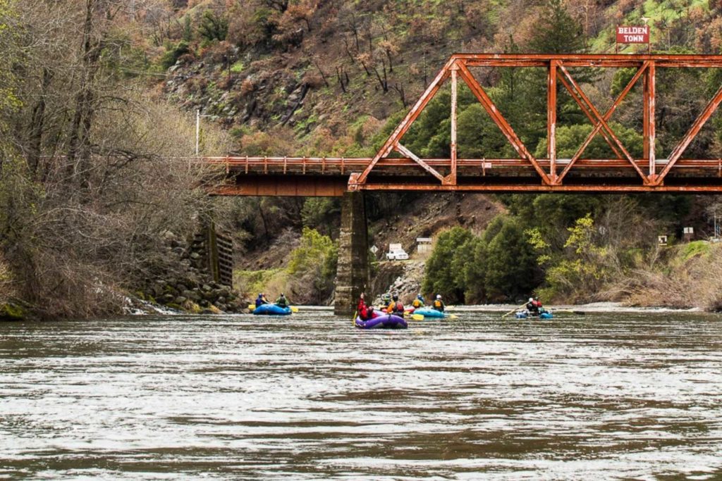 group rafting on feather river under bridge to belden town