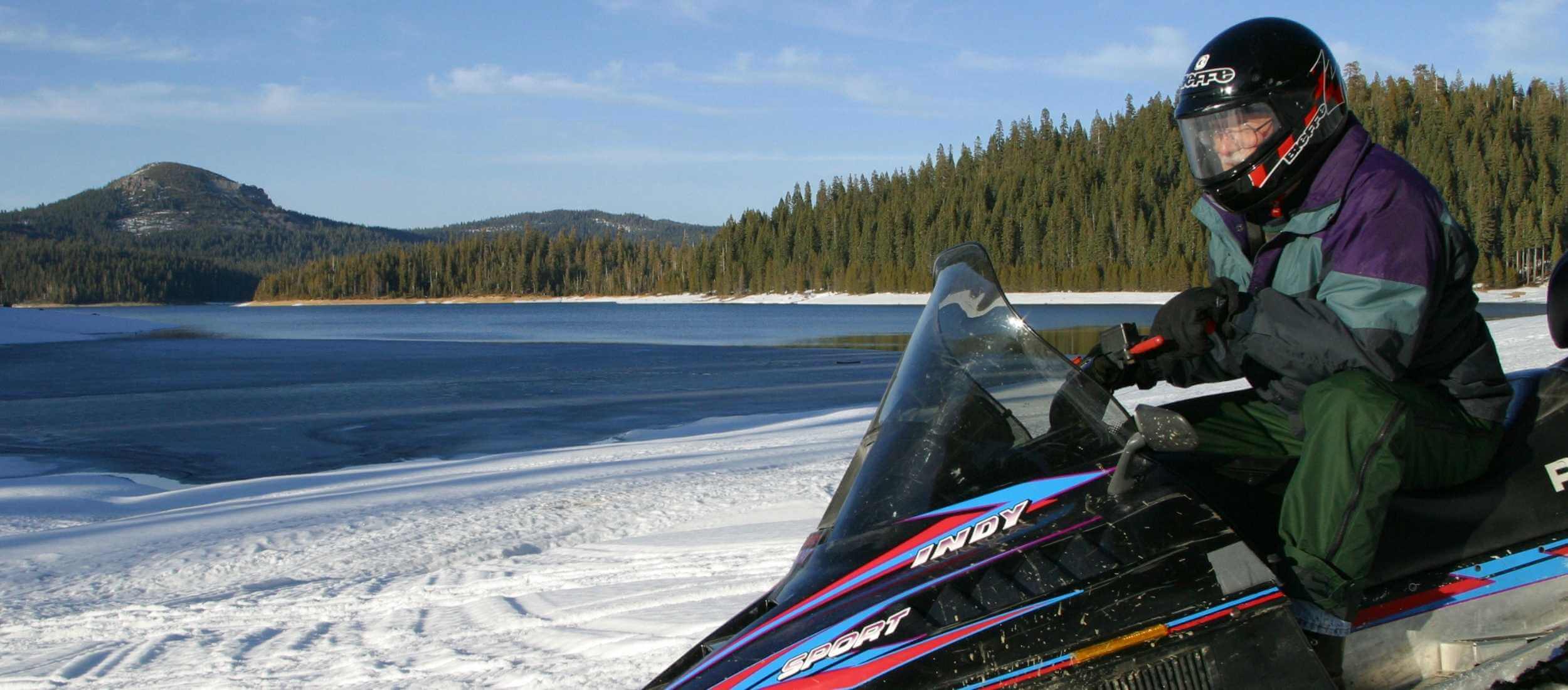 snow mobile with lake in background