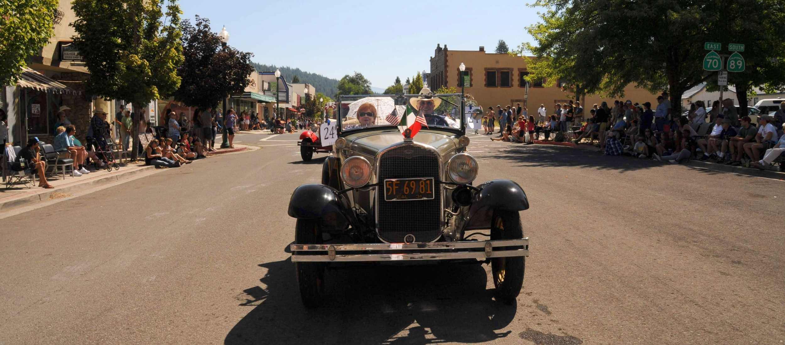 Couple in antique car for Quincy Parade