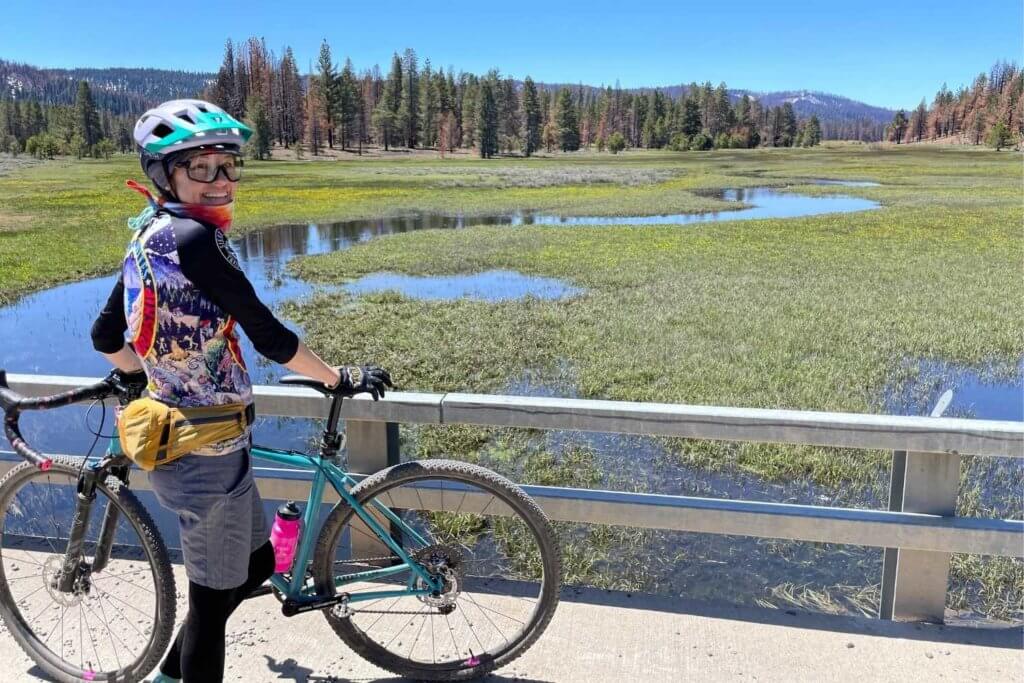 woman with mountain bike by lake davis