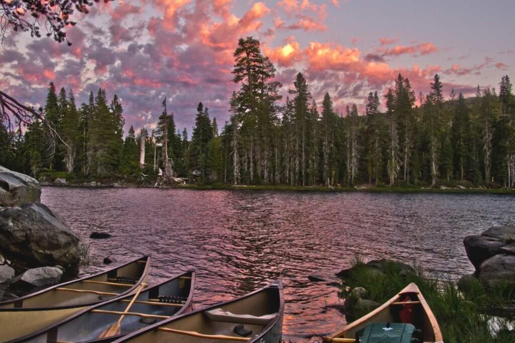 canoes on lake with sunset