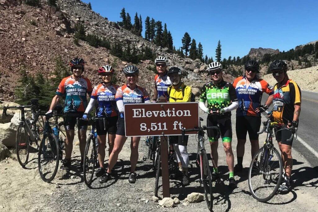 The Plumas-Sierra Bicycle Club in Northern California Stopping for photo at the highest elevation of paved road in the Cascades