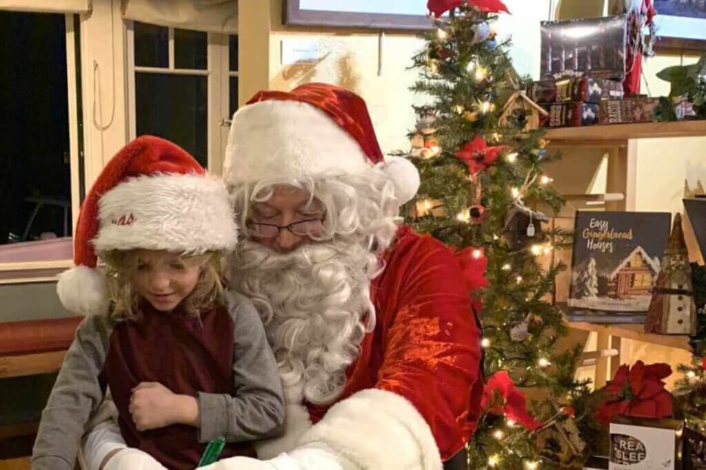 Santa, a young girl, and a tree in a Chester shop