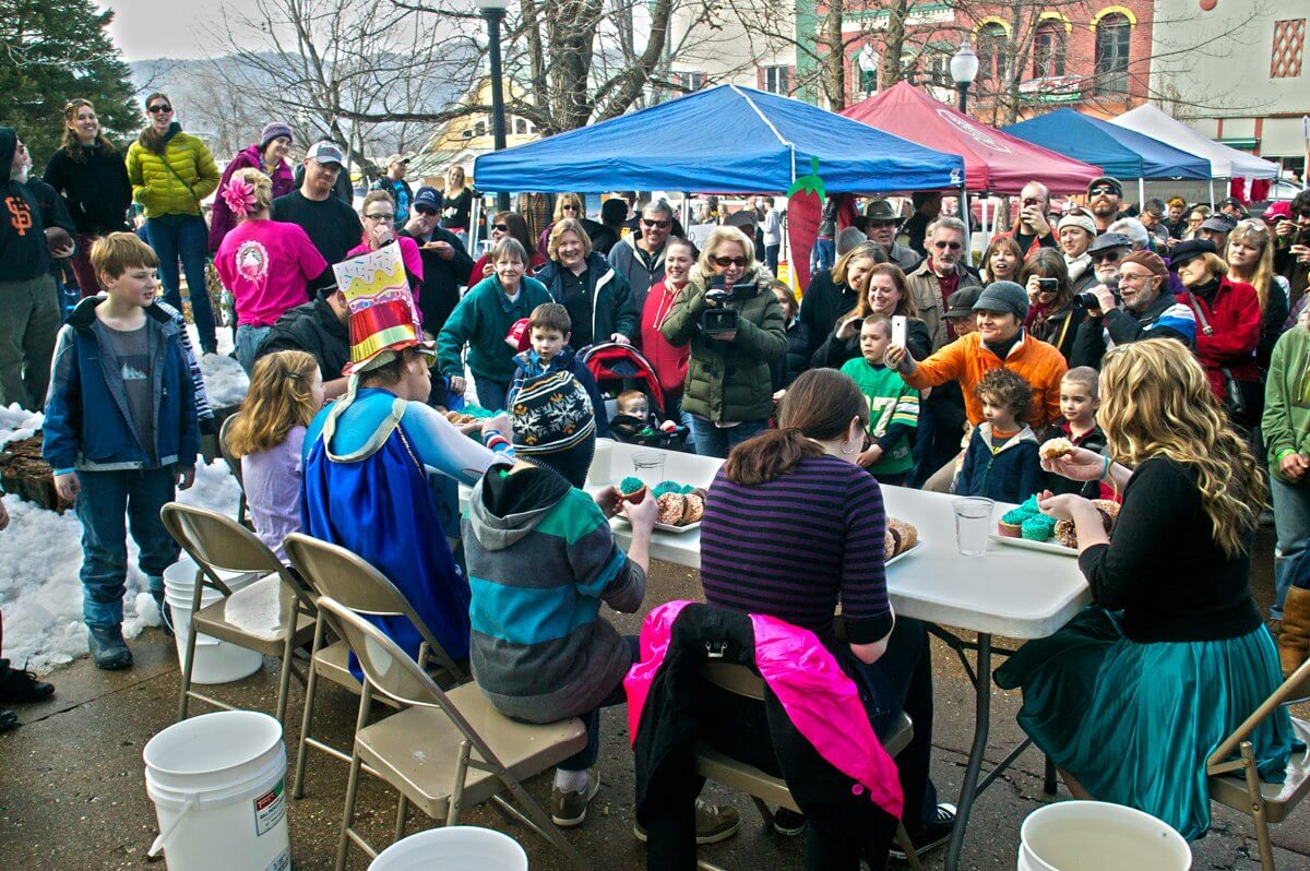 people at food eating competition at groundhog festival in quincy