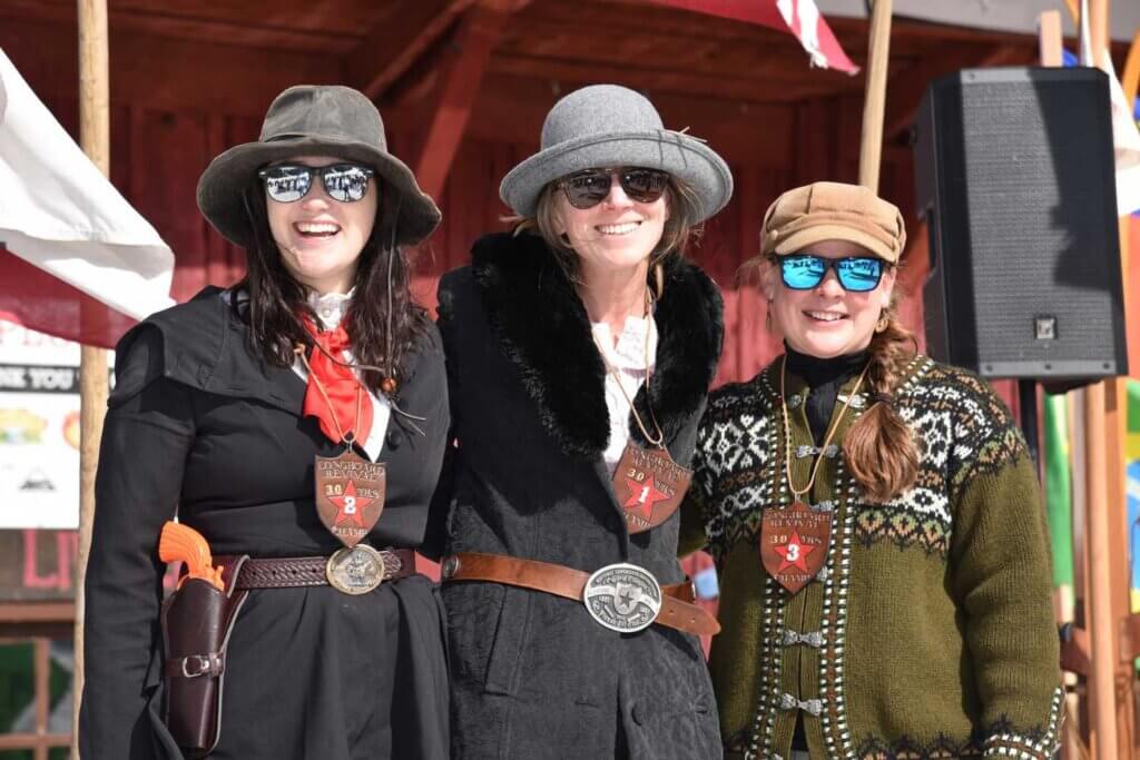 three women dressed in period dress for the World Championship Longboard Races