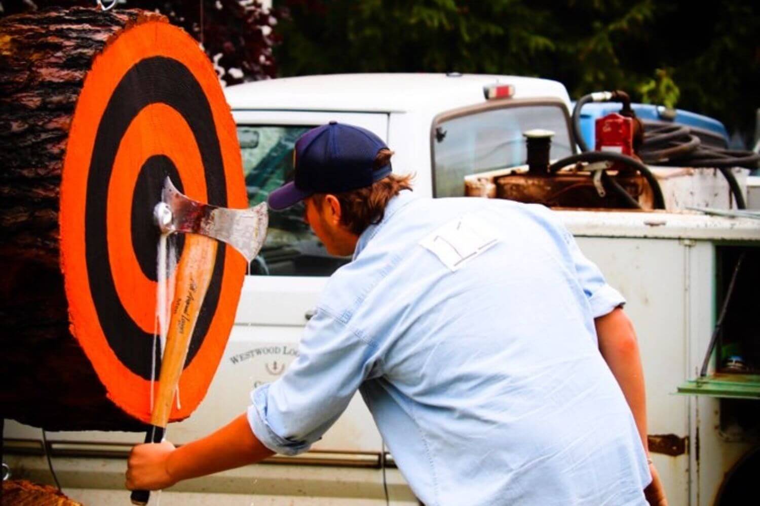 Man removing his axe from bulls eye