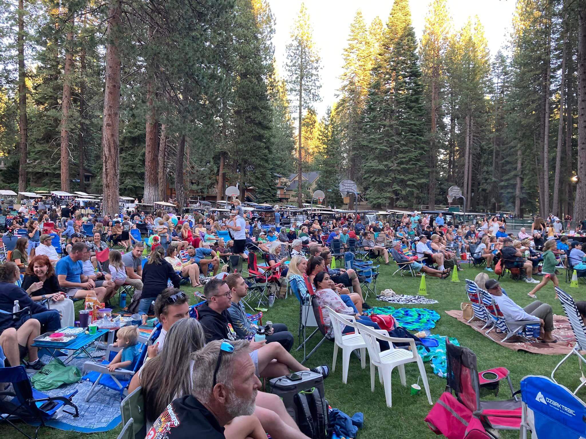 View of people in lawn chairs enjoying the music at the Lake Almnaor Country Club Music Series