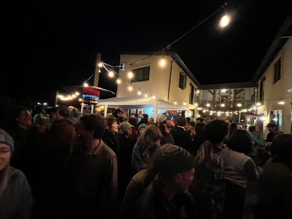 Night shot of group of people enjoying a concert at Drunk Brush